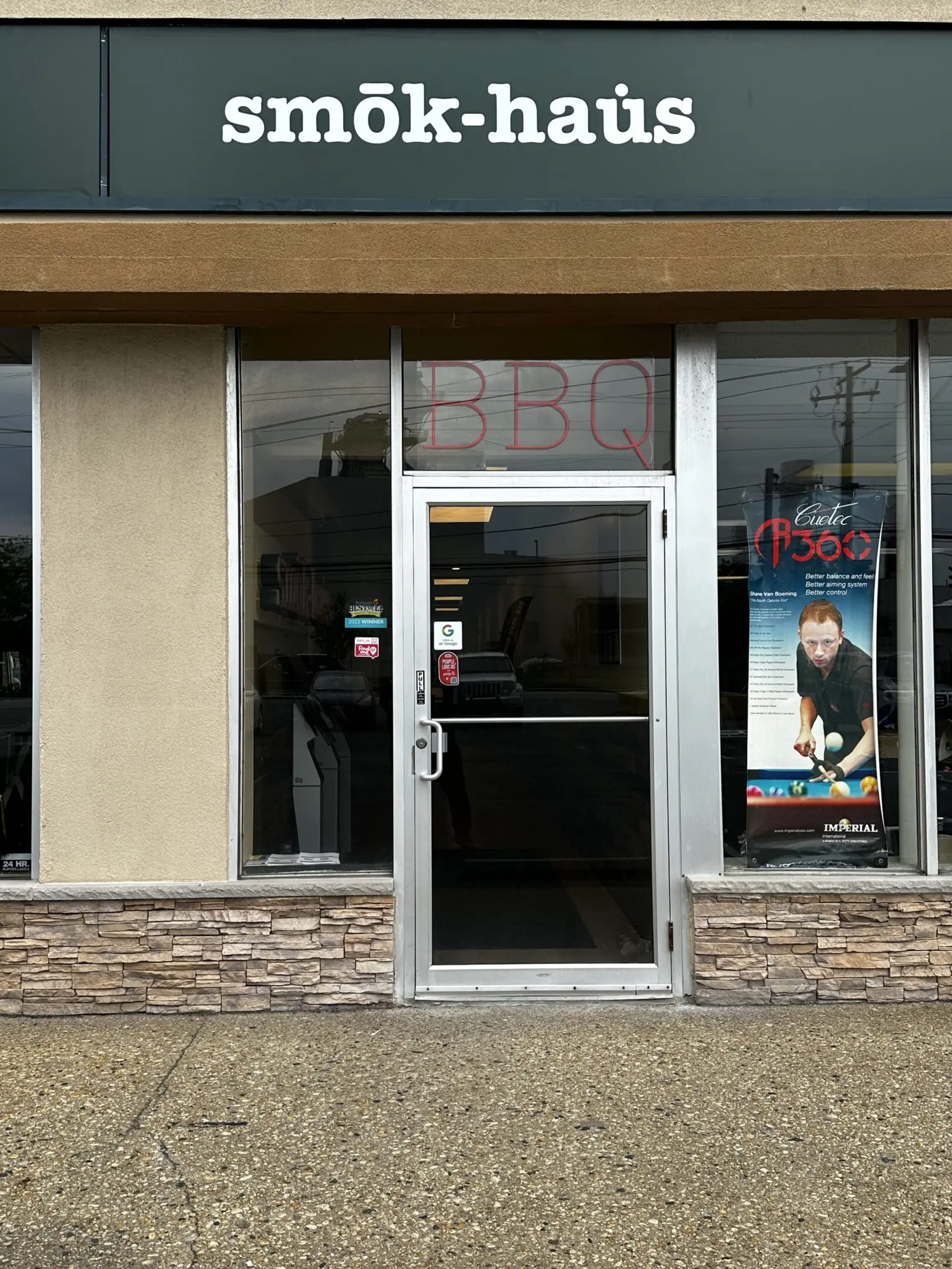 A store front with two windows and a door.